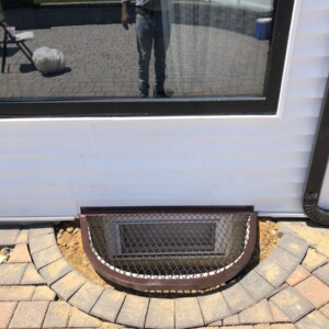 Leaking basement window replaced with new well and drain with fresh stone